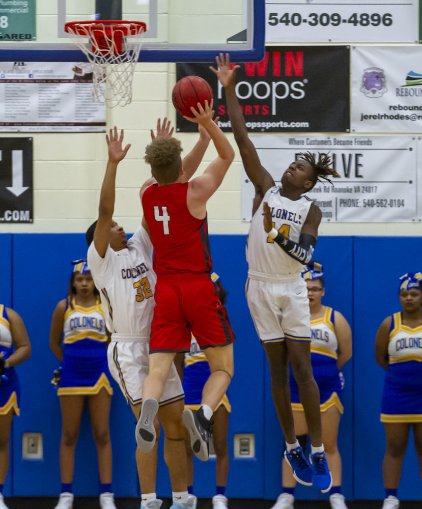 William Fleming's (14) Christian Goode and (32) Alexander Fuller both go up to try and block the shot by Lord Botetourt's (4) Kyle Arnholt.